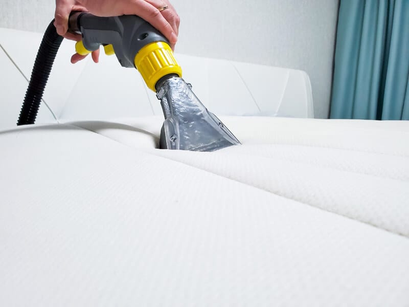 Mattress Hot Water Extraction Surrey White mattress being cleaned with a hot water extraction tool