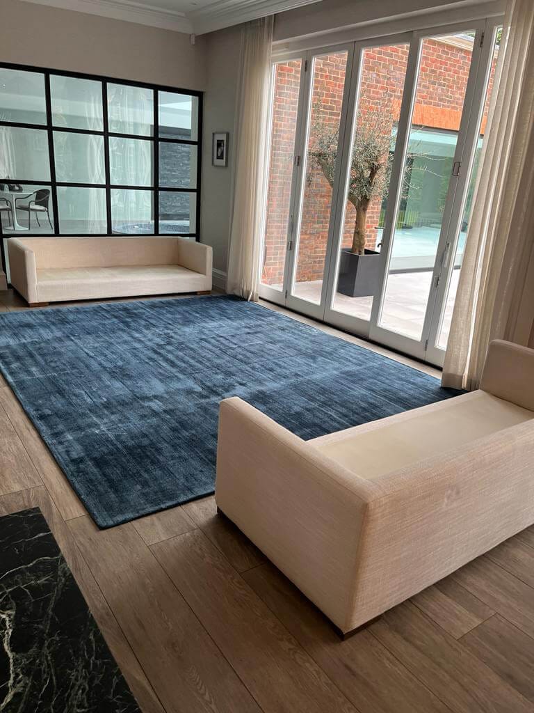 Living Room Rug Cleaning Surrey Large blue rug in a bright living room after a professional rug clean in Surrey
