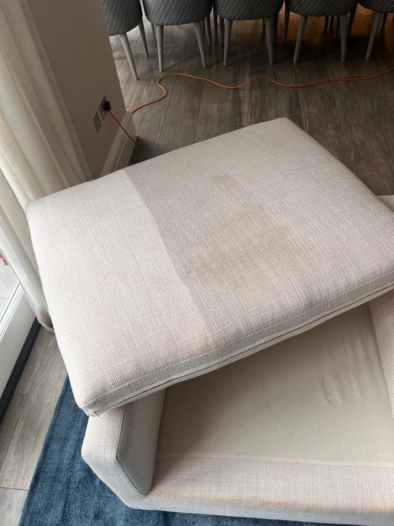 Upholstery Cushion Cleaning Surrey Sofa cushion part way through an upholstery clean, showing the cleaned and uncleaned fabric